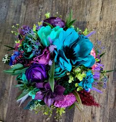 a bouquet of flowers sitting on top of a wooden table