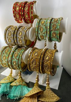 several bracelets are hanging on a rack with tassels