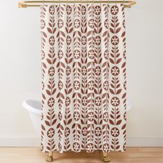 a brown and white shower curtain with an abstract design in the center on a wooden floor