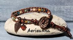 Passage Leather Wrap Bracelet by Aerieanna Made with 100% USA naturally dyed leather in dark brown and an assortment of gemstone beads that can include African Turquoise, Lapis Lazuli, Red Jasper, Clear Quartz, Rose Quartz, Landscape Jasper, Unikite, Carnelian, Mookite, Sodalite, Amethyst with two Czech fire-polished crystals. Wire wrapped beady dangles. Closes with a copper shell button at 7.5 or 8.5". Not your size? Request a custom order! Leather Gemstone Bracelet, Adjustable Brown Leather Bracelet With Natural Stones, Bohemian Leather Wrap Bracelet Adjustable, Bohemian Leather Wrap Bracelet, Adjustable, Bohemian Hand Wrapped Brown Bracelets, Bohemian Adjustable Leather Wrap Bracelet, Adjustable Leather Bohemian Wrap Bracelet, Bohemian Leather Bracelet With Natural Stones, Bohemian Beaded Leather Wrap Bracelet