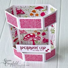 an open box with pink and green designs on it