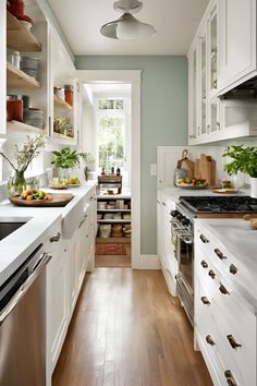 the kitchen is clean and ready for us to use it's white cabinetry