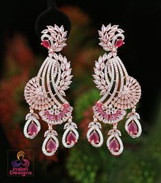 These Rose Gold Polish American Diamond CZ Stone Studded Drop Dangle Earrings are the epitome of luxury and style. Perfect for party wear, these earrings are inspired by Celebrity and Indian Bollywood styles. The Diamond Look CZ Diamond color stones are arranged in a unique peacock design, making these earrings a true work of art from Indian designs. Add a touch of glamour to any outfit with these stunning earrings. American Diamond Earrings, Bridal Statement Earrings, Peacock Earrings, Party Kleidung, Bollywood Jewelry, Peacock Design, Cz Jewelry, Design Earrings, Stone Studs