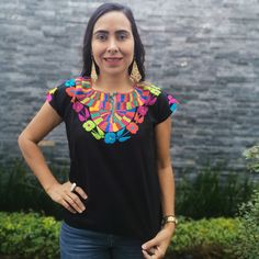 Beautiful colorful Hand Embroidered Mexican Flower Shirt made in Chiapas, Mexico. Cotton Shirt can be machine washed in cold water, hang to dry and warm iron. Each shirt is hand embroidered and flower will vary but each one is beautiful and unique Any questions please feel free to contact me DOES NOT INCLUDE THE BELT Traditional Black Shirt With Floral Embroidery, Folk Style Multicolor Top With Geometric Embroidery, Black Tops With Floral Embroidery For Festivals, Black Floral Embroidered Tops For Festivals, Festival Embroidered Multicolor Top, Casual Multicolor Embroidered Top With Embroidered Border, Casual Multicolor Tops With Embroidered Border, Multicolor Short Sleeve Tops With Embroidered Neckline, Casual Multicolor Top With Embroidered Border