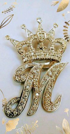 a gold brooch with a crown on it