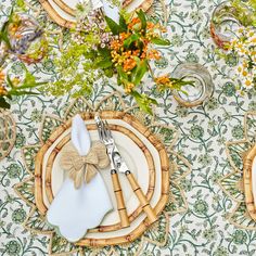 the table is set with place settings and flowers