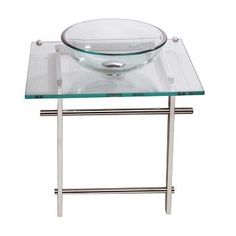 a glass table with metal legs and a bowl on top that is sitting on a white background