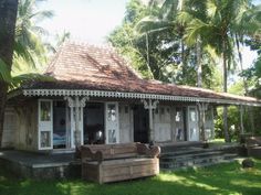 an old wooden house in the middle of palm trees