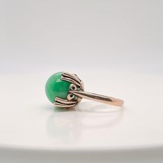 A very fine 14k gold and jade bead Art Deco style ring.  With a large jadeite bead prong set in a 14k gold architectural setting.  Simply a wonderful ring!  Date: Early to Mid 20th Century  Overall Condition: It is in overall good, as-pictured, used estate condition. There is mottling and a fine natural fissure visible to the top of the stone, as well as some very fine & light surface scratches and other signs of expected light wear consistent with age.  Fineness: Marked 14K for gold fineness. Art Deco Jade Jewelry For Formal Occasions, Formal Art Deco Jade Jewelry, Elegant Emerald Jade Ring With Cabochon, Fine Jewelry Chrysoprase For Formal Occasions, Formal Fine Jewelry With Chrysoprase, Formal Chrysoprase Fine Jewelry, Jade Beads, Art Deco Style, Bead Art