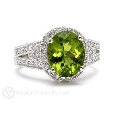 "An absolutely gorgeous vintage inspired Peridot and diamond ring with an Art Deco style and a stunning large 3 carat natural Peridot center and pave set diamonds. This Peridot ring has a diamond halo, and a unique diamond accented split shank design. This antique style August birthstone ring has all the design details you'd expect of an antique design, including pave set diamonds, beautiful filigree and engravings, and hand beaded milgrain. A stunning statement piece! Made to order. Please allo Earth Jewelry, August Birthstone Ring, Split Shank Engagement Rings, Kay Jewelry, Jewelry Real, Peridot Jewelry, Fine Diamond Jewelry, London Blue Topaz Ring, Vintage Style Rings