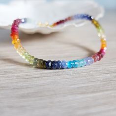 This rainbow bracelet has a great variety of natural gemstones. They are : Aquamarine, Tourmaline, Garnet, Ruby, Carnelian, Citrine, Peridot , Tanzanite, Apatite, And iolite A gorgeous fusion of colors in this multi stone precious  bracelet. A riot of vivid  colors  in ombre design I chose and  lined the gemstones to obtain this unique shaded colorful precious bracelet. It will be beautiful alone or together with other gemstones stacking bracelets The gemstone beads are strung on the highest qua Rainbow Natural Stones Beaded Bracelets For Jewelry Making, Rainbow Gemstone Beads Bracelets For Jewelry Making, Rainbow Gemstone Beads For Jewelry Making, Rainbow Gemstones For Jewelry Making, Spiritual Multicolor Faceted Beaded Bracelets, Rainbow Gemstone Beaded Bracelet, Rainbow Multi-stone Bracelets As A Gift, Multicolor Faceted Spiritual Bracelets, Multicolor Gemstone Beaded Bracelets For Jewelry Making