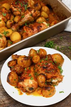 a white plate topped with potatoes next to a casserole dish filled with chicken