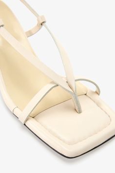 Strappy sophistication. Our Greta Sandals feature a modern square toe and an adjustable slingback strap for a flattering look, enhanced by a chic kitten heel and minimalist raw edges. Whether it's running between meetings or dancing the night away, their padded soles and soft Italian leather let you do it all in comfort—and impeccable style.[SPLIT] Astrid wears Greta in cream, in disco, and in black. Heel height is approximately 2" (5 cm). Sold in US sizes, though please note that shoes may be l Modern Slingback Sandals With Wrapped Heel, Cream Kitten Heels For Summer, Modern Slingback Sandals With Padded Heel, Summer Cream Kitten Heels With Ankle Strap, Cream Ankle Strap Kitten Heels For Summer, Spring Kitten Heels With Padded Heel And Square Toe, Cream Sandals With Square Toe For Evening, Evening Sandals With Square Toe In Cream, Cream Slingback Sandals For Summer Evenings