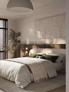 a large bed sitting in a bedroom next to a window with blinds on the windowsill