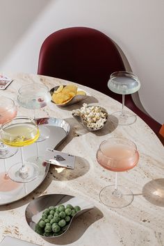 several glasses of wine and snacks on a table