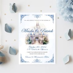 a wedding card with a castle in the middle and stars around it on a table