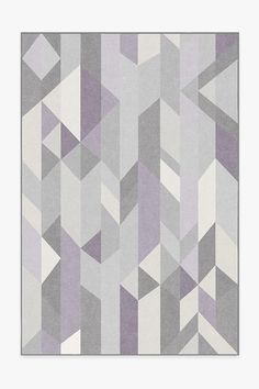 a gray and white rug with an abstract design on the bottom corner, in front of a light grey background