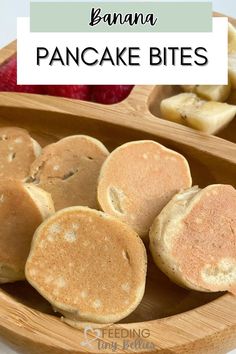 banana pancakes in a wooden plate with fruit on the side