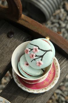 tea cups and saucers are stacked on top of each other, with pink flowers painted on them