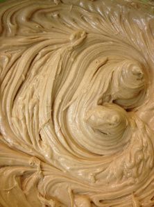 a bowl filled with cream sitting on top of a table