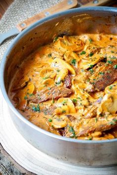 a pan filled with pasta and meat covered in cheese