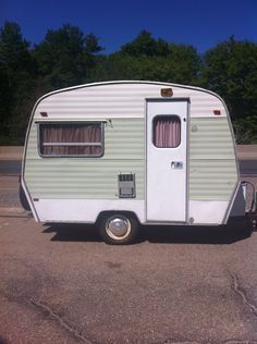 an old trailer is parked in the parking lot