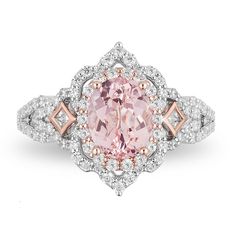 a pink diamond ring with diamonds around the band and an oval shaped center stone on top