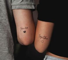 two people with matching tattoos on their arms, one has the word together and the other has