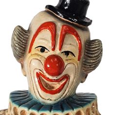 a ceramic clown's head with a top hat