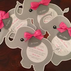 four elephant shaped cards with pink bows on them