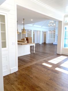 an empty living room with hard wood floors