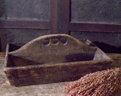 an old wooden box sitting on top of a table next to a pile of dirt