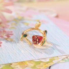 Indulge in the beauty of love and passion with our Rose Enamel Ring. Handcrafted with delicate and sophisticated touches, this romantic piece is adorned with a stunning rose design. Its eye-catching and adorable appeal is suitable for any occasion, making it the perfect addition to your jewelry collection! DETAILS Plating: 18K Gold Materials: 18K Gold on Brass, Enamel Size: Adjustable, 0.51 "*0.47"/13mm*12mm Weight: 4.7 g Luxury Flower Shaped Enamel Ring As Gift, Elegant Flower Rings For Valentine's Day, Elegant Flower Open Ring For Valentine's Day, Elegant Rose Flower Ring For Gift, Elegant Open Flower Ring For Valentine's Day, Elegant Rose Flower Ring As Gift, Elegant Rose-colored Flower Ring For Gift, Elegant Rose Colored Flower Ring As Gift, Elegant Rose-colored Flower Ring As Gift