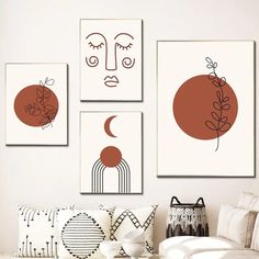 three abstract paintings hang on the wall above a couch in a living room with white furniture