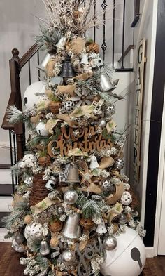 a christmas tree decorated with silver and white ornaments