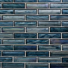 a close up view of the blue glass tile in this kitchen backsplash,