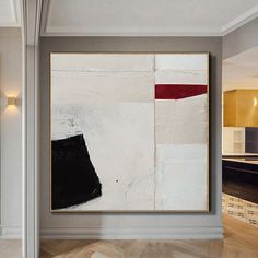 an abstract painting hangs in the middle of a room