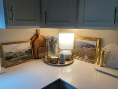 a kitchen counter topped with pictures and candles