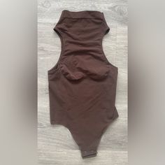 Skims Cocoa Brown Mock Neck Bodysuit Size 3x Nwot. Perfectly Crafted From A Combination Of Nylon And Spandex, This One-Piece Bodysuit Is Lightweight, Stretchy, And Has A Firm Compression Level For A Slimming Effect. The Features Of This Bodysuit Include A Sleeveless Design, Perfect For Layering With Your Favorite Outfits. This Size Looks Smaller Than The Tag Says, I Recommend This For 1x-2x Mock Neck Bodysuit, Cocoa Brown, Sleeveless Bodysuit, One Piece Bodysuit, Mock Neck, Cocoa, Favorite Outfit, Layering, One Piece