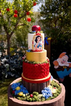 a three tiered cake on top of a wooden table