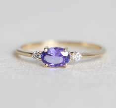 Opal And Tanzanite Ring, Timeless Oval Tanzanite Rings, Oval Three Stone Amethyst Ring, Fine Jewelry, Timeless Oval Rings With Gemstone Accents, Oval Three-stone Amethyst Ring, Dainty Oval Amethyst Wedding Ring, Oval Sapphire Ring With Gemstone Accents, Elegant Oval Three-stone Amethyst Ring, Oval Amethyst Ring For Wedding