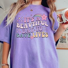 Get ready to fall in LOVE with your new 'It's a Beautiful Day to Save Lives' retro printed comfort colors t-shirt. It's the cutest and most comfortable way to wear the latest styles, and also makes a great gift.  * PRODUCT DETAILS * ✺ 100% Cotton ✺ Medium weight fabric  ✺ Wash and dry normally (on cool for best results) ✺ Designed and printed in the USA ✺ Due to different monitor screens, colors may vary ✺ * SIZING * ✺ FOR AN OVERSIZED FIT, SELECT TWO OR THREE SIZES UP FROM YOUR NORMAL SIZE ✺ ✺ Retro Purple Cotton Shirt, Trendy Purple Shirt With Letter Print, Relaxed Fit Purple Shirt With Letter Print, Purple Cotton Retro Shirt, Purple Cotton Tops With Graphic Design, Trendy Purple Cotton Shirt, Cute Purple Shirt With Graphic Print, Purple Letter Print Shirt For Spring, Multicolor Cotton Slogan Shirt