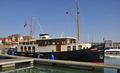 a boat is docked in the water next to a dock