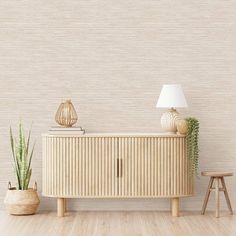 an empty room with a sideboard and two small stools in front of it