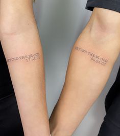 two people with tattoos on their arms that say, beyond the blood i go to bed