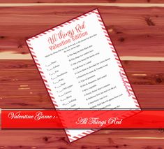 an all things red valentine's printable game is shown on a wooden background