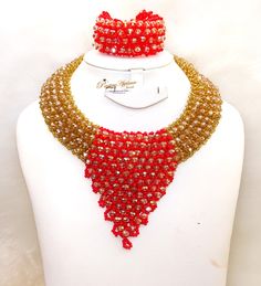 Cheap Sales Blue & Gold Peach African Nigerian Necklace Jewellery Fashion Set  Complete Set is Necklace Earring and bracelet Wedding Party Bridal Special Occasion This detailed Jewellery set makes you stand out elegantly in any special occassion, it's all about glamour and uniqueness.  Buying more that 1 Jewellery set, we offer wholesale and bulk prices for all our jewellery. Elegant Red Beaded Jewelry Set, Red Crystal Bridal Necklace For Party, Red Adjustable Round Jewelry Sets, Red Crystal Party Necklace, Handmade Red Jewelry Sets For Party, Elegant Red Beaded Bridal Necklace, Red Wedding Jewelry Sets With Round Beads, Red Crystal Bracelet For Wedding, Multicolor Gold Beaded Jewelry For Wedding