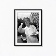 a black and white photo of a chef giving the thumbs up sign with his hand