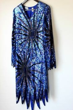 "Fun and funky Vintage Sequin Flapper inspired dress..timeless style for your one of a kind type of night.. This slips over the head. All the beads and sequins are in Very Good condition..i do not see any missing..although i might have missed something..this is all silk..beads and sequins. Lovely Zig zag hem. This is very small. It is a straight dress..so if you want it to fit loose, remember those measurements. Measuring: 36\" - 38\" long (zig zag hem) Sleeves: 22\" Width: Bust/hip/waist: 34\" Vintage Embellished Flapper Dress For Costume Party, Fitted Art Deco Flapper Dress For Night Out, Fitted Art Deco Party Dresses, Vintage Embellished Flapper Dress For Party, Vintage Flapper Dress For Evening Party Season, Bohemian Flapper Dress With Sequins For Party, Costume Dresses With Sequins For Party Season, Blue Fitted Dress For Carnival, Costume Sequin Dresses For Party Season