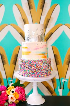 a wedding cake with sprinkles on it and the caption says, i didn't want to look like a typical white